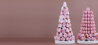 A pink strawberry tower with fresh Colombian roses, orchids and edible pearls and a pink macaron tower with Colombian roses